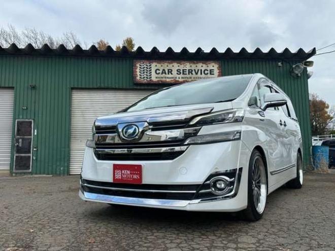 ヴェルファイアハイブリッド 2.5 V E-Four 4WD　社外アルミ　オートミラー　ETC　ドライブレコーダー　ローダウン　ワンオーナー　両側電動スライドドア　パワステ　パワーウィンドウ　ベージュ革シート　純正ナビ　バックカメラ　ABS　キーレスエントリー 2500