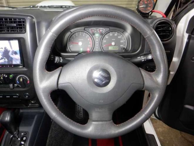 ジムニーワイルドウインド 4WD　本州仕入・ナビ・TV・Bカメラ・専用レザーシート・ETC・キーレス・シートヒーター・フォグランプ・ターボ・純正AW・電動格納ミラー・ミラーヒーター・ルーフレール 660