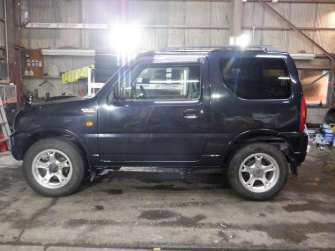 ジムニーワイルドウインド 4WD　本州仕入・ナビ・フルセグTV・キーレス・フォグランプ・シートヒーター・ミラーヒーター・ルーフレール・ターボ・社外AW・ライトレベライザー・電動格納ミラー・DVD再生・JAOSマッドガード 660