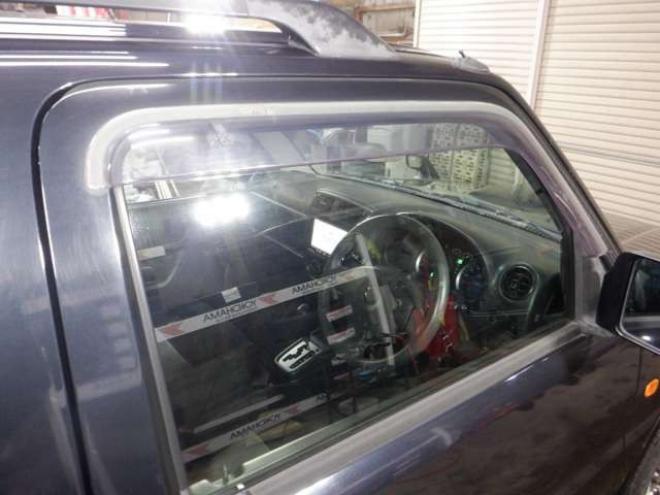 ジムニーワイルドウインド 4WD　本州仕入・ナビ・フルセグTV・キーレス・フォグランプ・シートヒーター・ミラーヒーター・ルーフレール・ターボ・社外AW・ライトレベライザー・電動格納ミラー・DVD再生・JAOSマッドガード 660